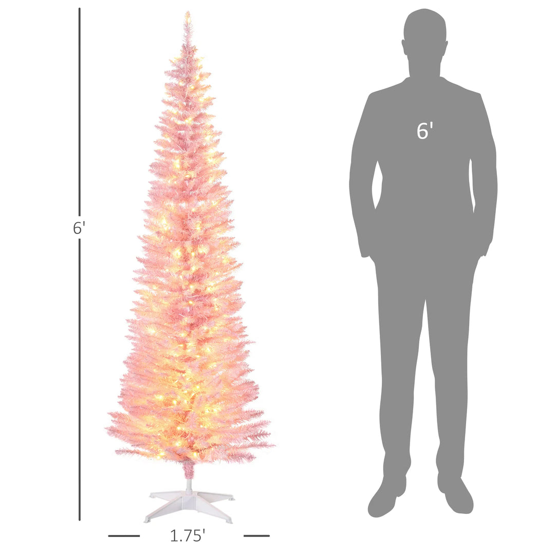 Rosa smalt juletre med mange varme lys